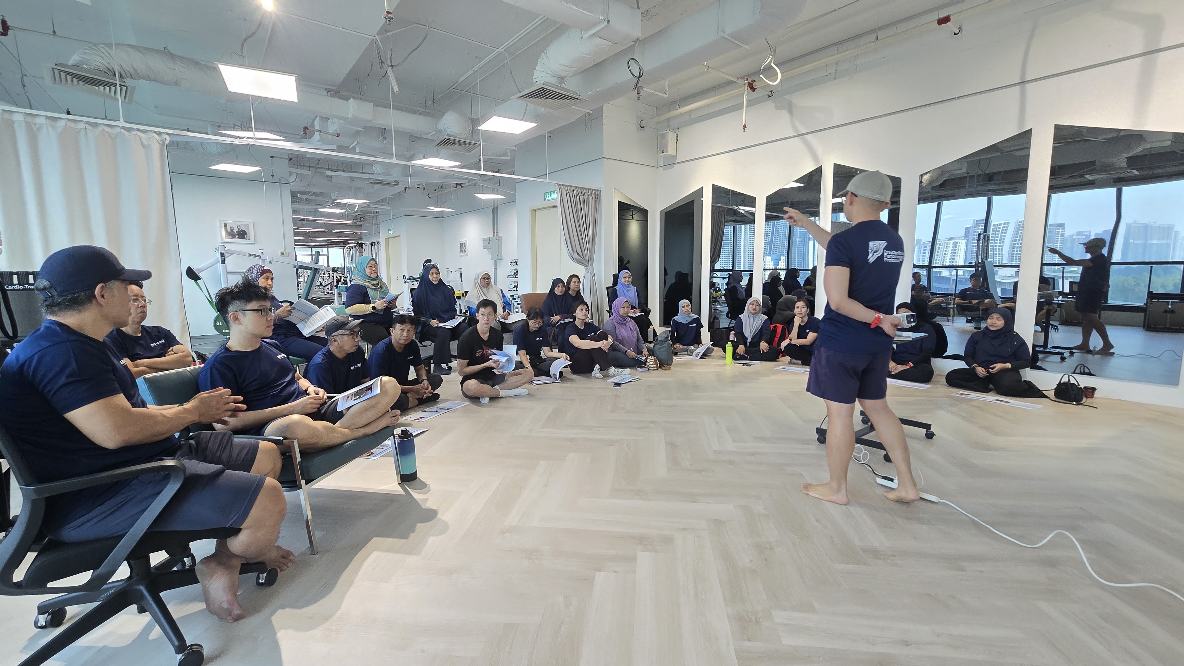 Coach Ho leading a practical training session for a group